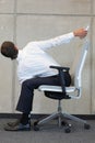 Yoga on chair in office - business man exercising Royalty Free Stock Photo