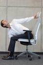 Yoga on chair in office - business man exercising Royalty Free Stock Photo