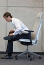 Yoga on chair in office - business man exercising