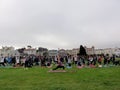 Yoga Class Does Warrior One in Grass Field