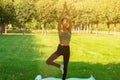 Yoga class on nature, teenager girl does exercises, trains, sports and fitness outdoor Royalty Free Stock Photo