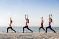 Yoga class outdoor on the sandy beach at sunset,Healthy Lifestyle concept Royalty Free Stock Photo