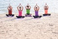 Yoga class at sea beach in evening ,Group of people doing tree poses with relax emotion at beach,Meditation pose,Wellness and Royalty Free Stock Photo