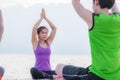 Yoga class at sea beach in evening sunset ,close up master teach Royalty Free Stock Photo