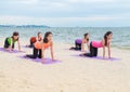 Yoga class at sea beach in evening sunset ,Group of people doing Royalty Free Stock Photo