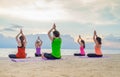 Yoga class at sea beach in evening sunset ,Group of people doing Royalty Free Stock Photo