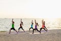 Yoga class at sea beach in sunset time ,Group of people doing Wa Royalty Free Stock Photo