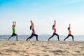 Yoga class at sea beach in sunset time , Group of people doing Wa Royalty Free Stock Photo