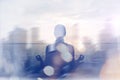 Yoga concept. Double exposure. Woman doing yoga practice on the beach and silhouette of modern city Royalty Free Stock Photo