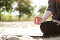 Yoga concept. woman hand practicing lotus pose on the beach at sunset
