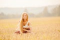 Yoga concept. Young woman dawn performs workout in park, yellow grass field