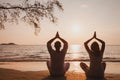 yoga for couple, healthy lifestyle and harmony in relations, silhouettes of man and woman meditatiing Royalty Free Stock Photo