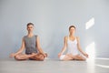 Yoga couple people hand sitting relaxation in lotus field on floor in studio class. Royalty Free Stock Photo