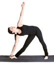 Yoga excercising utthita trikonasana Royalty Free Stock Photo
