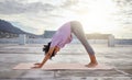Yoga exercise, city rooftop and woman bending down for balance, wellness and health on an urban building in the morning Royalty Free Stock Photo