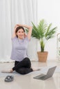 Yoga exercise concept, Young Asian woman stretching and doing yoga exercise training online at home Royalty Free Stock Photo