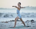 Yoga, exercise and fitness woman at beach for warrior pose for balance, zen and peace during nature workout for health Royalty Free Stock Photo