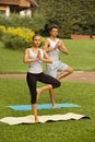 Yoga Exercise. Young couple meditating in fitness club Royalty Free Stock Photo