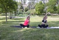 Yoga fitness exercise in the park. Stretching of arms and shoulders.