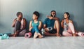 Yoga, fitness group and diversity of pilates class in a gym with a exercise and training break. Talking, wellness people Royalty Free Stock Photo