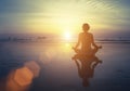 Yoga, fitness and healthy lifestyle. Silhouette meditation girl on the background of the stunning sea and sunset. Royalty Free Stock Photo