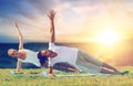 Couple doing yoga and side plank outdoors Royalty Free Stock Photo