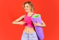 Yoga, fitness. Smiling woman with yoga mat. Healthy lifestyle concept. Sporty girl. Sport advertising. Royalty Free Stock Photo