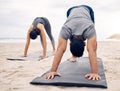 Yoga, fitness and wellness with a couple on the beach for a mental health or awareness workout in the morning. Exercise Royalty Free Stock Photo