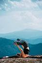 Outdoor shot of woman doing yoga exercise at the hill Royalty Free Stock Photo