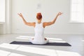 Yoga girl. Backview. Fitness girl is practicing yoga in a lotus position sitting in a studio Royalty Free Stock Photo