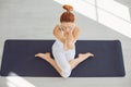 Yoga girl. Fitness girl is practicing yoga in a lotus position sitting in a studio Royalty Free Stock Photo