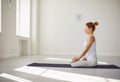 Yoga girl. Fitness girl is practicing yoga in a lotus position sitting in a studio Royalty Free Stock Photo