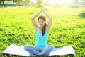 Yoga girl meditates sitting on grass pose lotus in summer