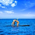 Yoga girl over SUP Stand up Surf board Royalty Free Stock Photo