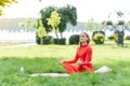 Yoga girl in the summer park meditation. Young woman relax and exercising in nature wooden pier with blue cloudy sky and green Royalty Free Stock Photo