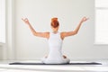 Yoga girl. Backview. Fitness girl is practicing yoga in a lotus position sitting in a studio Royalty Free Stock Photo