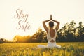 Concept image of woman doing yoga or meditation with text Stay Safe Royalty Free Stock Photo