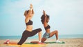 Yoga girls on beach. afro hair girl and blond girl training yoga meditation together on the sea side