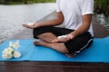 Yoga hand meditation exercise near pond