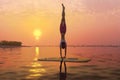 yoga handstand pose on paddleboard, generative Ai