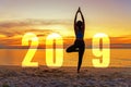 Yoga Happy new year card 2019. Silhouette woman practicing yoga standing as part of Number 2019 Royalty Free Stock Photo