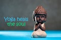 Yoga heals the soul - motivational inscription on picture with baby buddha