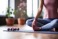 Yoga at home exercise in living room house - woman on fitness mat training stretching legs touching toes