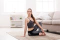 Yoga at home. Woman stretching seated spinal twist pose Royalty Free Stock Photo