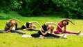 Yoga for inner harmony. Multinational women on their morning practice at park Royalty Free Stock Photo