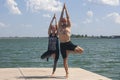 Yoga inspiration. Top view - couple of cheerful healthy beautiful slim man and woman are doing virabhadrasana Royalty Free Stock Photo