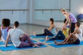 Yoga instructor helping student with a correct pose Royalty Free Stock Photo