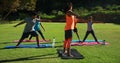 Yoga instructor instructing children in performing exercise