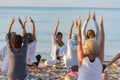 Yoga instructor leading a group session at sunset on the beach in Altafulla, Tarragona, Spain