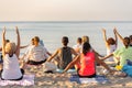Yoga instructor leading a group session at sunset on the beach in Altafulla, Tarragona, Spain
